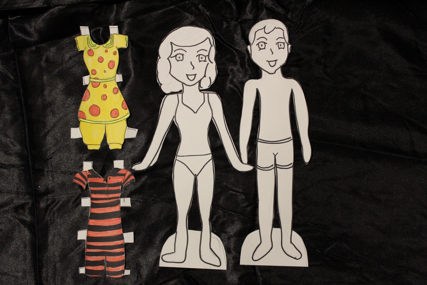 Hand-painted paper dolls with mix-and-match outfits