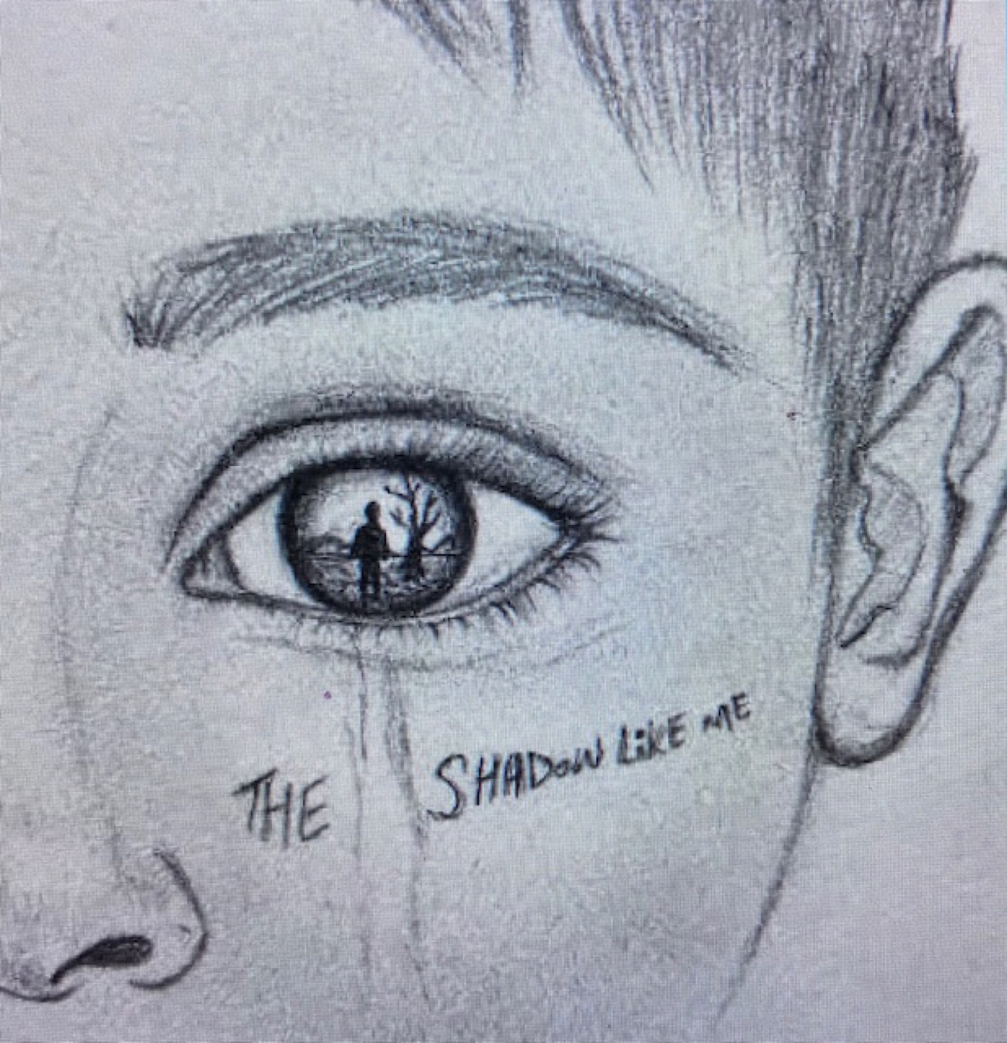 Student pencil drawing of an eye reflecting a lone figure