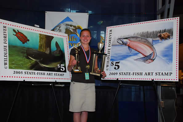 Young artist holding trophies at Wildlife Forever State-Fish Art Stamp contest